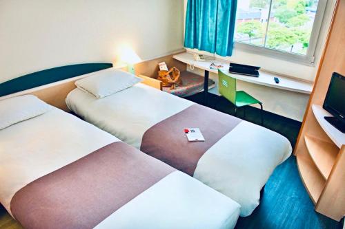 Habitación Doble Estándar - 2 camas del hotel Ibis Strasbourg Aéroport Le Zenith. Foto 3