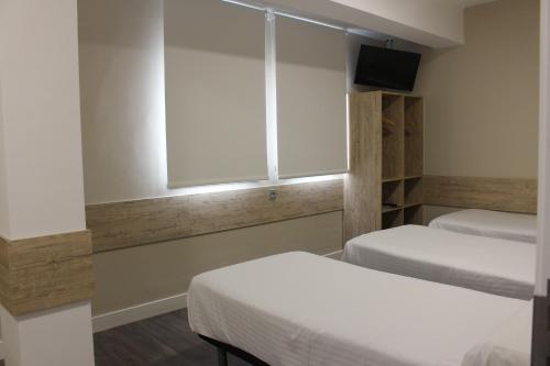 Habitación Cuádruple Deluxe del hotel Deluxe Hostels And Suites Merida. Foto 1