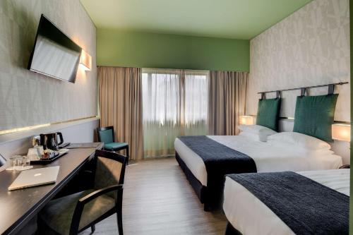Habitación Clásica con 1 cama grande y 1 cama individual del hotel Best Western Plus CHC Florence. Foto 10