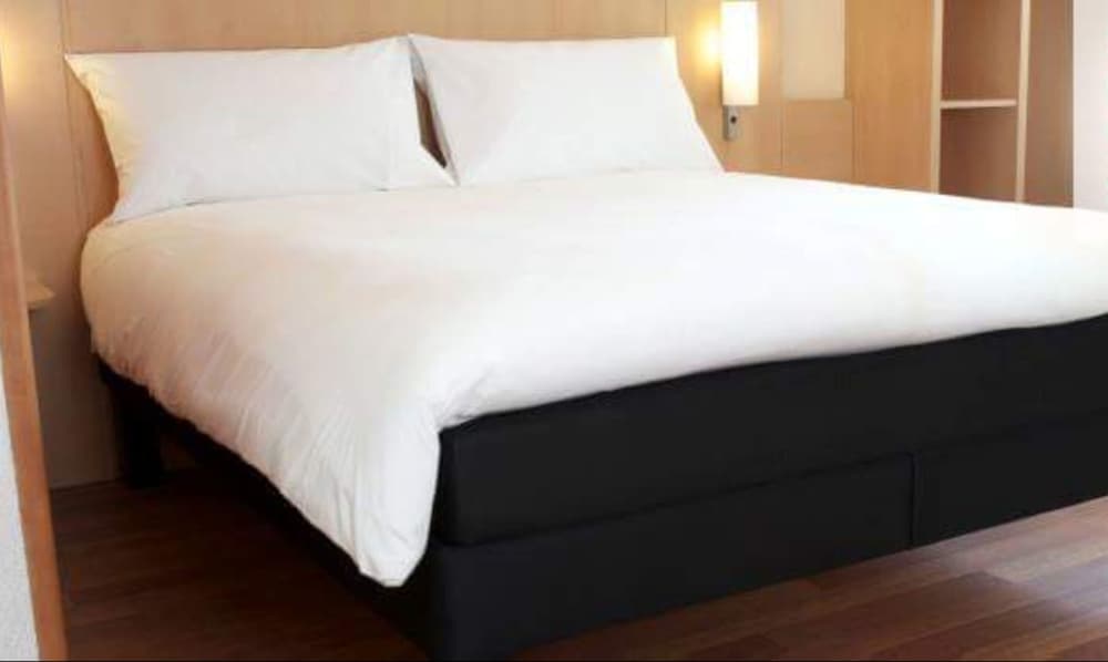 Habitación con 2 camas individuales equipadas con la nueva ropa de cama del hotel Ibis Douala. Foto 1