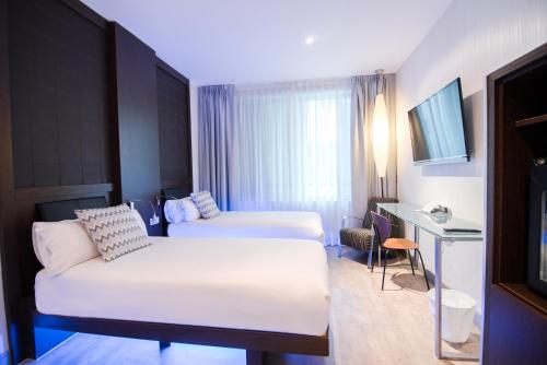 Habitación Triple del hotel Petit Palace President Castellana. Foto 1