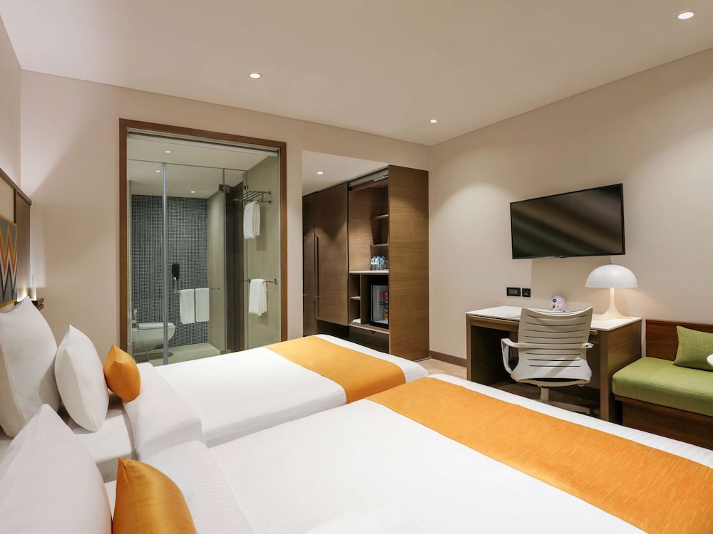 Habitación superior con 2 camas individuales, vistas a la ciudad del hotel Novotel Guwahati Gs Road. Foto 1
