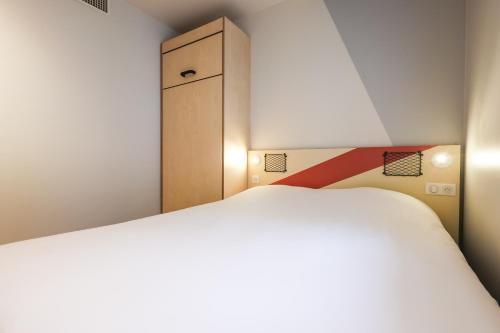 DORMITORIO - con una cama grande y un armario del hotel Ibis Budget Villemomble. Foto 9