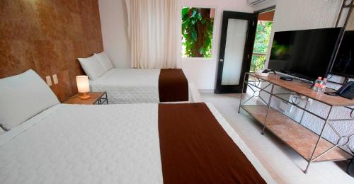 Habitación Deluxe del hotel Tukan Hotel Playa del Carmen. Foto 1