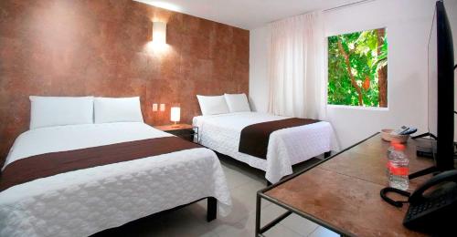 Habitación Deluxe del hotel Tukan Hotel Playa del Carmen. Foto 5