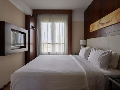 Suite Junior con cama grande y sofá cama del hotel Mercure Belo Horizonte Lourdes. Foto 2