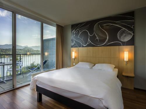 Habitación superior con la garantía de confort de sueño definitivo de Sweet Bed by ibis y vistas al lago del hotel Ibis Wörthersee
