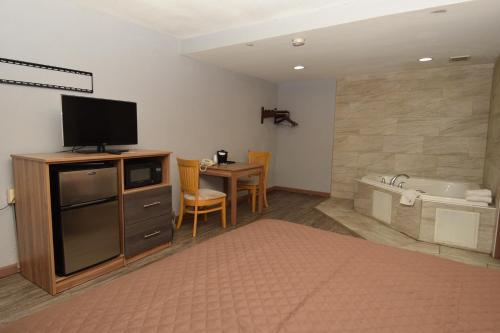 Habitación con cama grande y bañera de hidromasaje - Fumadores del hotel University Manor Inn. Foto 13