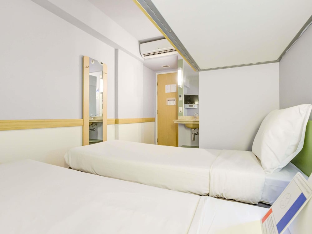 Habitación estándar con dos camas individuales y una litera del hotel Ibis Budget Rj Copacabana. Foto 3