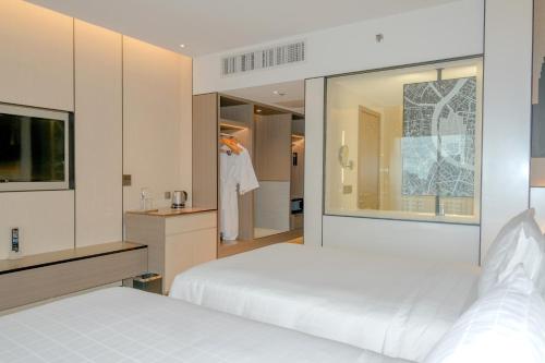 Habitación Grand Deluxe - 2 camas del hotel Pathumwan Princess. Foto 2