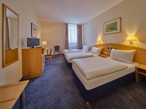 Habitación Triple del hotel YORS Hannover. Foto 1