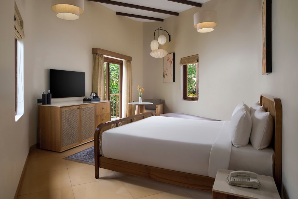Suite Deluxe con acogedor salón, terraza privada y vistas panorámicas al río del hotel Mercure Goa Devaaya Resort. Foto 1