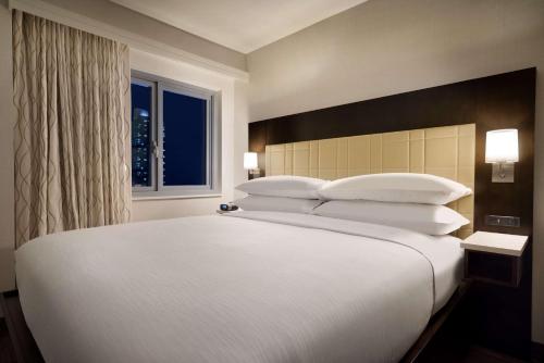 Suite Estudio adaptada para personas con discapacidad auditiva con vistas - Cama extragrande del hotel Embassy Suites By Hilton New York Manhattan Times Square. Foto 1