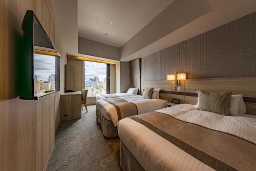 Habitación Confort con 2 camas individuales y cama supletoria - Planta Superior - No fumadores del hotel KEIHAN TSUKIJI GINZA GRANDE