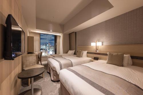 Habitación Confort con 2 camas individuales y cama supletoria - Planta Superior - No fumadores del hotel KEIHAN TSUKIJI GINZA GRANDE. Foto 1