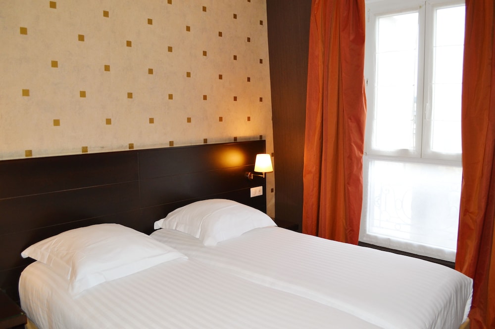 Habitación con 2 camas individuales del hotel Exposition Tour Eiffel. Foto 3