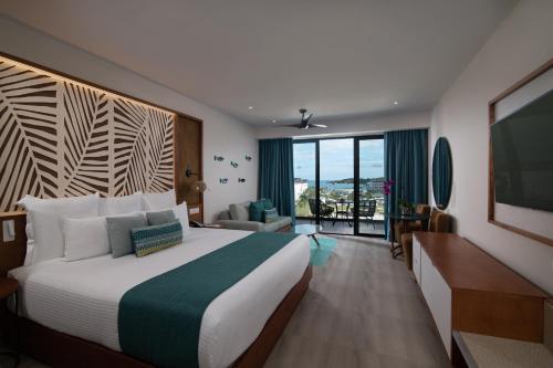 Suite Junior con vista parcial al mar y cama extragrande del hotel Dreams Macao Beach Punta Cana