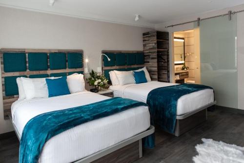 Alojamiento Signature Collection con 2 camas dobles del hotel Le Bleu. Foto 1
