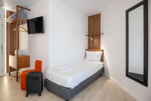 Habitación Triple Deluxe del hotel The Icons Lisbon Central. Foto 6