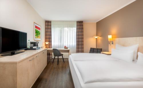 Habitación Superior con cama extragrande del hotel Sunday Bielefeld Johannisberg. Foto 8