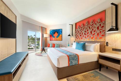 Alojamiento Deluxe con vistas parciales al océano - 1 cama extragrande del hotel Dreams La Romana All-Inclusive Resort and Spa