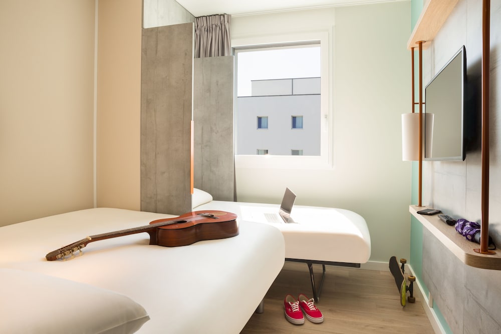 Habitación con 1 cama grande, 1 cama plegable y baño cómodo del hotel ibis budget Fribourg. Foto 2