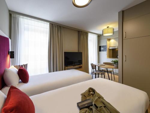 Estudio con 2 camas individuales del hotel Adagio Zurich Center. Foto 1