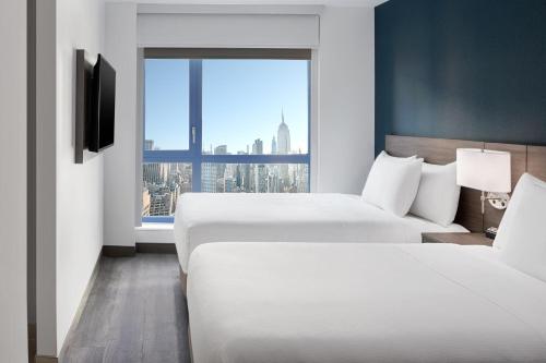 Habitación Doble con 2 camas dobles y vistas al perfil urbano del hotel Hyatt Place New York / Chelsea. Foto 6