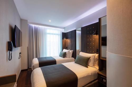 Habitación acogedora, incluye 2 camas del hotel Point A Dublin Parnell Street. Foto 10