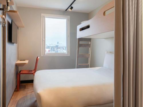 Habitación con una cama grande y una litera del hotel Ibis Budget Issy Les Moulineaux Paris Ouest. Foto 1