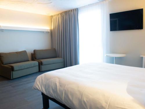 Habitación Deluxe con 1 cama doble y 2 sofás - cama individuales del hotel Ibis Montlhery Paris Sud. Foto 3