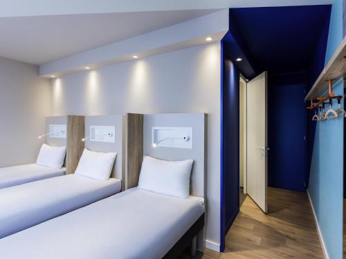 3 camas individuales del hotel Ibis Budget Amsterdam City South. Foto 3
