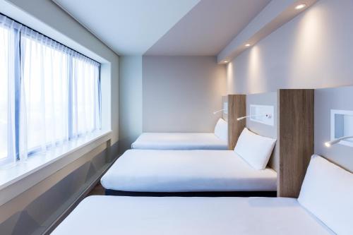 3 camas individuales del hotel Ibis Budget Amsterdam City South. Foto 5