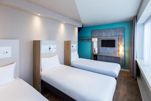 3 camas individuales del hotel Ibis Budget Amsterdam City South. Foto 6