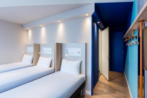 3 camas individuales del hotel Ibis Budget Amsterdam City South. Foto 8