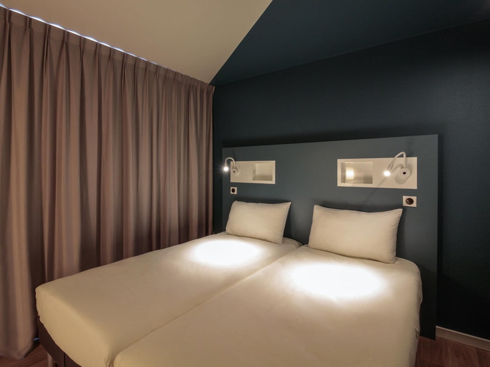 Habitación con 1 cama doble y 2 camas individuales del hotel ibis budget Rouen Centre Rive Gauche. Foto 1