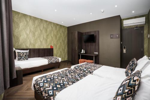 Habitación Triple del hotel Damsquare. Foto 1
