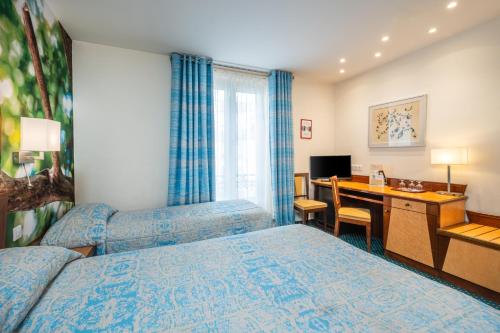 Habitación Triple Executive del hotel Terminus Montparnasse. Foto 1