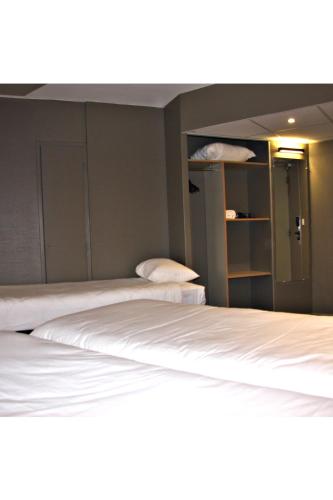 Habitación Estándar con 3 camas individuales del hotel Ibis Toulouse Purpan. Foto 3