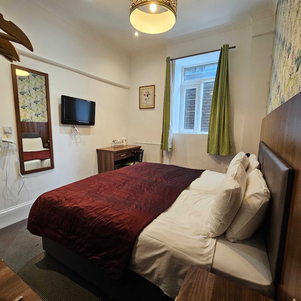 Habitación con 2 camas individuales del hotel Chelsea House. Foto 1