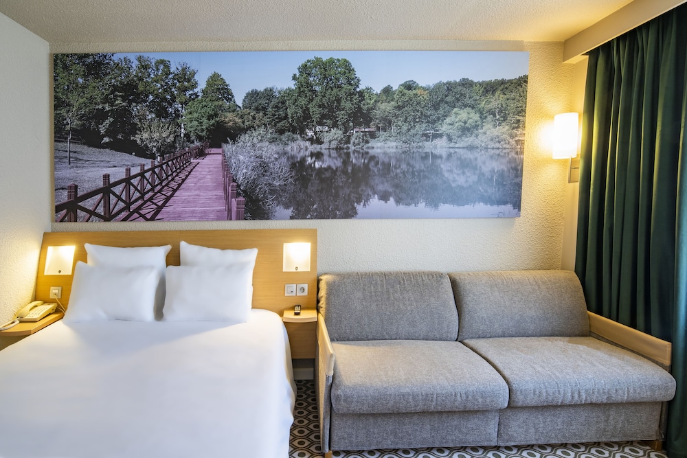 Habitación Superior con cama doble y sofá cama doble del hotel Novotel Orléans Chemins Sologne - Demeures Campagne. Foto 5