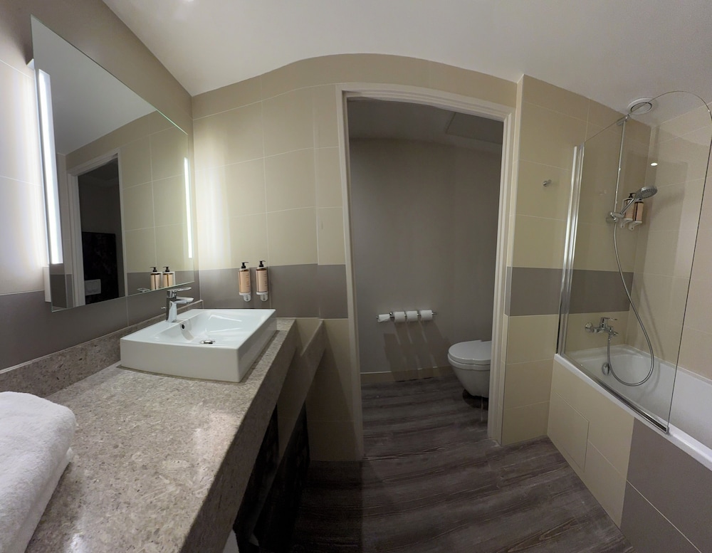 Suite con una cama doble y un sofá cama individual del hotel Mercure Paris Orly Rungis Aéroport. Foto 6