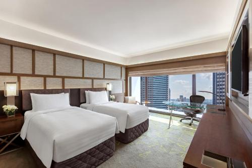 2 habitaciones comunicadas Deluxe Panorámica con vistas a la ciudad - Planta alta del hotel Pan Pacific Singapore. Foto 2
