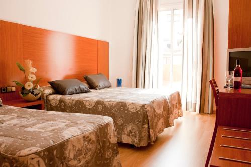 Habitación Doble con cama supletoria del hotel Ramblas Barcelona. Foto 3
