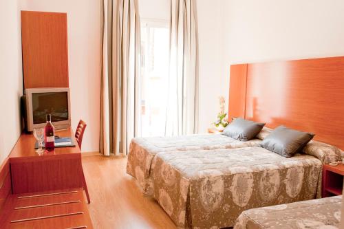 Habitación Doble con cama supletoria del hotel Ramblas Barcelona. Foto 12