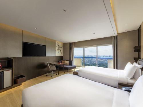 Alojamiento Executive con 2 camas dobles, acceso al salón L65, balcón y vistas a la ciudad - Planta superior del hotel Swissotel The Stamford, Singapore. Foto 1