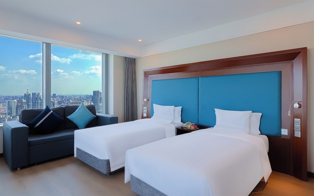 Habitación superior, 2 camas individuales del hotel Novotel Shanghai Atlantis. Foto 1