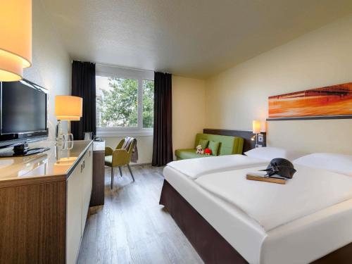 Habitación Doble Estándar con sofá del hotel Mercure Köln West. Foto 1