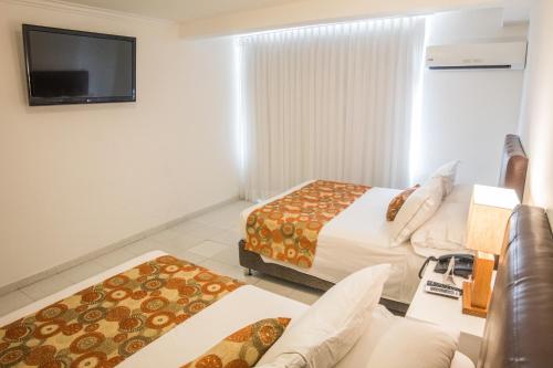 Habitación cuádruple del hotel Playa Club. Foto 4