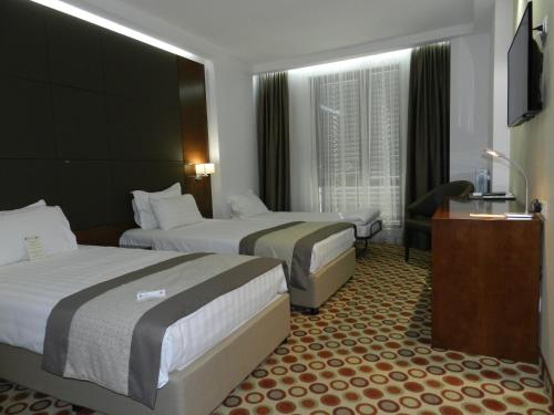 Habitación Deluxe con sofá cama del hotel Central Sofia. Foto 4